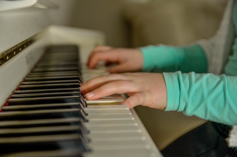 Child playing the piano in Southampton